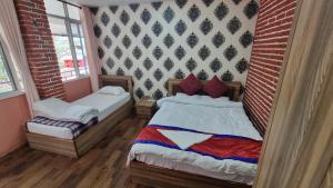 une chambre avec un lit et un mur de briques dans l'établissement Natural View Resort, à Burhānilkantha