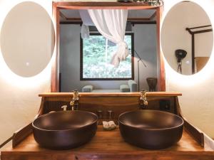 a bathroom with two vessel sinks in front of a mirror at LATERAL - Vacation STAY 36594v in Shiojiri