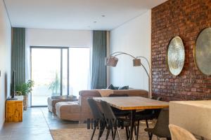 a living room with a couch and a table at Iconyc Apartment in Brentwood Park
