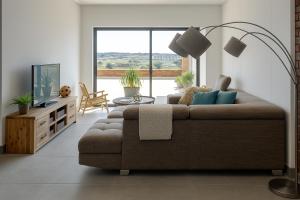 a living room with a couch and a large window at Iconyc Apartment in Brentwood Park
