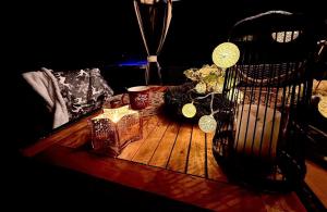 a wooden table with candles on it with a chair at Chalupy Severní in Lobendava +36 photos
