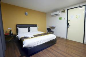 a hotel room with a bed and a chair at Hotel Sunjoy9 OKR Near Midvalley 10 Mins Only in Kuala Lumpur +49 photos