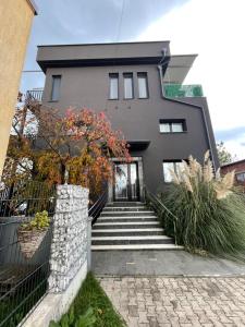 a house with stairs leading to the front door at Noce Rooms Zagreb in Zagreb
