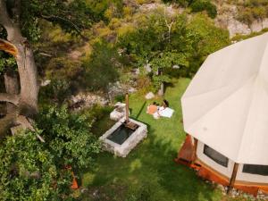two people sitting in the grass next to a house at Majestic wonders in Knysna