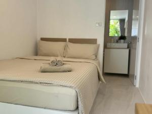 Una cama o camas en una habitación de SIAM LOUNGE - Pratumnak