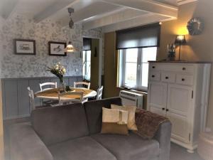 a living room with a couch and a table at Windekind Dh 2 in De Panne