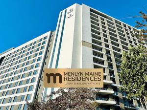a large building with a sign in front of it at Menlyn Maine Residences - Napoli with king sized bed in Pretoria