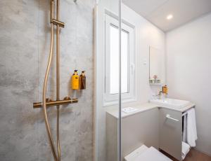 a bathroom with a shower and a toilet and a sink at Pinadria Adriatic Coast in Baška Voda +39 photos