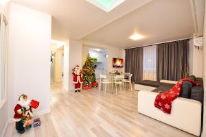a living room with a christmas tree and a couch at CityScape Bucharest in Bucharest +176 photos