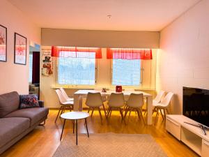a living room with a table and chairs at Large Group Fireside Cabin in Rovaniemi