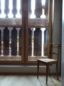 a chair sitting in front of a window at Biala Biobergün in Bergün +9 photos