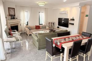 a living room with a couch and a table at Villa-Sleeps 9-Parking-Pool-Bbq-Hot tub-Pets in Dalyan