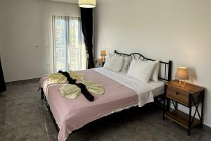 a bedroom with a large bed with a pink blanket at Villa-Sleeps 9-Parking-Pool-Bbq-Hot tub-Pets in Dalyan +54 photos