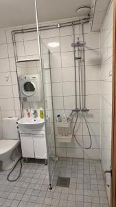 a bathroom with a shower and a toilet and a sink at Private House with Sauna and Winter Garden in Helsinki +40 photos