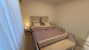 a small bedroom with two beds and a window at Private House with Sauna and Winter Garden in Helsinki