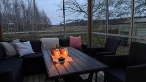 a living room with a couch and a table with candles at Private House with Sauna and Winter Garden in Helsinki