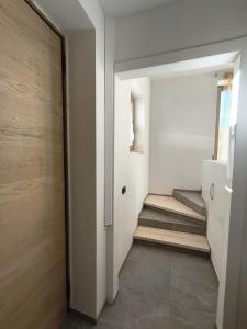 a hallway with a door and stairs in a house at Villa Raggio di Sole in Abbadia Lariana