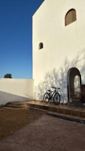 a bike parked on the side of a building at Wanasa Camel in Dahab