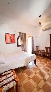 a bedroom with a bed in a room with a window at Wanasa Camel in Dahab