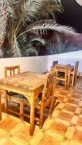 a wooden table and chairs in a room at Wanasa Camel in Dahab
