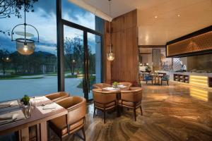 a kitchen and dining room with a large window at New Century Grand Hotel Zunyi in Zunyi