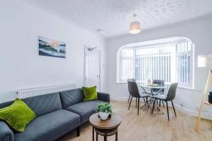 a living room with a couch and a table at Contractor Heaven Four Bedroom Free Parking in Manchester by Eason Stays in Little Hulton