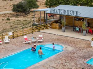 a group of people playing in a swimming pool at AfriCamps Klein Karoo in Oudtshoorn