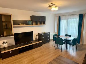 a living room with a table and a dining room at Dante Residence in Alba Iulia