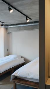 two beds in a room with at ART HOTELS SHIBUYA in Tokyo