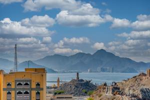 a view of a city and a body of water at The Living khorfakan Cornish 2 in Khor Fakkan