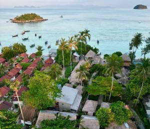 an aerial view of a resort with boats in the ocean at Hideaway, Koh Lipe in Ko Lipe