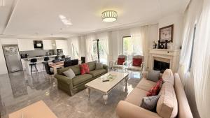 a living room with a couch and a table at Villa-Sleeps 9-Parking-Pool-Bbq-Hot tub-Pets in Dalyan