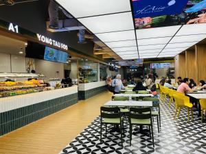 people sitting at tables in a fast food restaurant at Millennium Suites At Berjaya Times Square KL in Kuala Lumpur