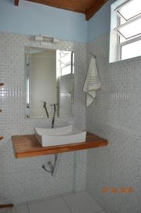 a bathroom with a white sink and a mirror at Pousada dos Franceses in Sao Paulo