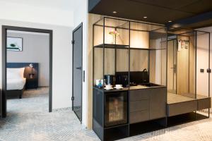 a hotel room with a kitchen and a bedroom at Q Hotel Plus Wrocław in Wrocław