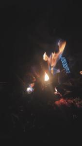 un focolare con una persona seduta intorno di Secret Shore N Tide Luxurious Suite , Sea Facing ad Alibaug