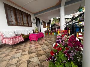 a living room filled with lots of flowers at V V Homestay in Darjeeling +37 photos