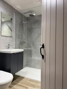 a bathroom with a shower and a toilet and a sink at The Hayloft our perfect countryside retreat in Stoney Middleton