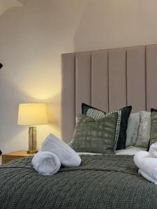 a bedroom with a bed with two towels on it at The Hayloft our perfect countryside retreat in Stoney Middleton