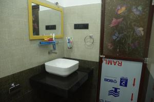 a bathroom with a white toilet and a mirror at sansandu breeze villa in Meda-Ela +8 photos