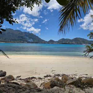 vistas a una playa con montañas en el fondo en Surf Tropical Villa Seascape, en Isla de Cerf