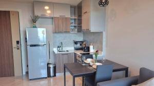 a small kitchen with a table and a refrigerator at Silk Ao Nang Condominium in Ao Nang Beach +228 photos