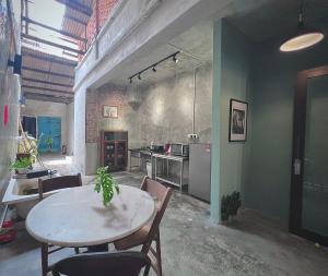 a kitchen with a table and chairs in a room at LEJU 79 樂居 A Heritage Getaway in the Heart of Melaka in Malacca