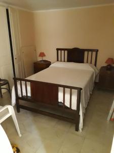 a bedroom with a bed with a wooden frame at Maison Puigpelat in Puigpelat
