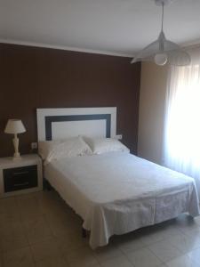 a bedroom with a white bed and a window at Maison Puigpelat in Puigpelat +23 photos