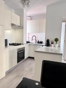 a white kitchen with white cabinets and a sink at Fairytale in Adeje in Adeje