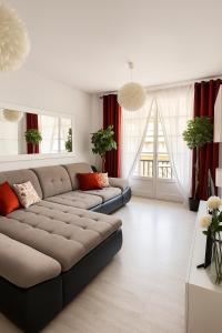 a living room with a couch and red curtains at Fairytale in Adeje in Adeje