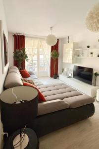 a living room with a large couch and a tv at Fairytale in Adeje in Adeje
