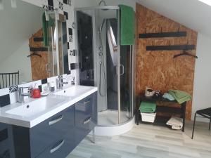 a bathroom with two sinks and a shower at comme chez nous 