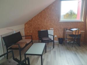 a room with two chairs and a table and a desk at comme chez nous 